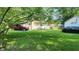Expansive backyard with lush green grass, detached garage, offering plenty of space for outdoor activities at 8201 S Burlington Dr, Muncie, IN 47302