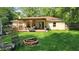 Backyard featuring a spacious deck with outdoor seating and a brick fire pit, perfect for entertaining at 8201 S Burlington Dr, Muncie, IN 47302