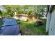 Backyard showcasing a covered patio, fence, and lush greenery at 8201 S Burlington Dr, Muncie, IN 47302
