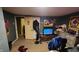 This bedroom features carpeted floors, an adjacent room, and various posters on the gray walls at 8201 S Burlington Dr, Muncie, IN 47302