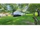 View of the detached garage with basketball hoop and driveway parking at 8201 S Burlington Dr, Muncie, IN 47302