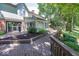 Backyard featuring a wooden deck, mature trees, and pathway that leads to the water at 8315 Union Chapel Rd, Indianapolis, IN 46240