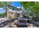 Backyard featuring a fire pit and outdoor seating on a wooden deck and mature trees at 8315 Union Chapel Rd, Indianapolis, IN 46240