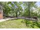 Backyard with wooden deck and patio surrounded by mature trees and grass at 8315 Union Chapel Rd, Indianapolis, IN 46240