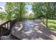 Wooden deck overlooking green grass, mature trees and pathway that leads to the water at 8315 Union Chapel Rd, Indianapolis, IN 46240