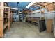 Unfinished basement with exposed joists, concrete walls and shelving at 8315 Union Chapel Rd, Indianapolis, IN 46240