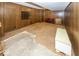 Spacious carpeted basement with wood paneled walls and some furniture at 8315 Union Chapel Rd, Indianapolis, IN 46240