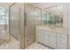Bathroom showcasing a glass-enclosed shower, vanity with a mirror, and tiled floor at 8315 Union Chapel Rd, Indianapolis, IN 46240