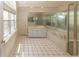 Bathroom featuring a shower, vanity, soaking tub, tile floors, and bright natural light at 8315 Union Chapel Rd, Indianapolis, IN 46240