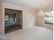 Bright dining room featuring a chandelier and large window with a view of the landscaped yard at 8315 Union Chapel Rd, Indianapolis, IN 46240