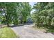 Long driveway of home with a glimpse of the waterfront and ample parking nestled among mature trees at 8315 Union Chapel Rd, Indianapolis, IN 46240