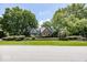 Charming brick and green two-story home with mature trees and manicured landscaping at 8315 Union Chapel Rd, Indianapolis, IN 46240