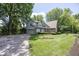 Two story brick and siding home with attached garage and mature trees at 8315 Union Chapel Rd, Indianapolis, IN 46240