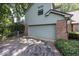 Spacious two-car garage with brick accents and neutral siding, providing ample storage and curb appeal at 8315 Union Chapel Rd, Indianapolis, IN 46240