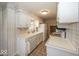 Traditional style kitchen with white cabinetry, tile floors and laminate countertops at 8315 Union Chapel Rd, Indianapolis, IN 46240