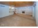 Open living room featuring fireplace with built-ins, wood-paneled ceiling, and sliding doors to outside at 8315 Union Chapel Rd, Indianapolis, IN 46240