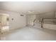 Spacious living room with an adjacent staircase and doorway leading to an additional room at 8315 Union Chapel Rd, Indianapolis, IN 46240
