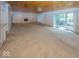 Large living room with wood-paneled ceiling, a fireplace, and sliding glass doors leading to the outside at 8315 Union Chapel Rd, Indianapolis, IN 46240