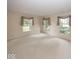 Spacious living room with three windows offering views of the outdoors, creating bright living space at 8315 Union Chapel Rd, Indianapolis, IN 46240