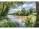 Picturesque river view with clear water reflecting the sky and trees, with ducks swimming by at 8315 Union Chapel Rd, Indianapolis, IN 46240