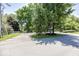 Street view with mature trees, landscaping, and a driveway entrance in a residential neighborhood at 8315 Union Chapel Rd, Indianapolis, IN 46240