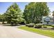 Street view of a home showcasing manicured landscaping, mature trees, and a well-maintained lawn at 8315 Union Chapel Rd, Indianapolis, IN 46240