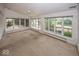 Light-filled sunroom with wall of windows, offering panoramic views of the surrounding landscape at 8315 Union Chapel Rd, Indianapolis, IN 46240