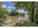 Beautiful waterfront view with mature trees, blue sky and wispy clouds at 8315 Union Chapel Rd, Indianapolis, IN 46240