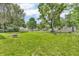 The backyard features a lush green lawn, fire pit, and tire, and is surrounded by fencing and other homes at 850 Duane St, Franklin, IN 46131