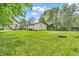 The backyard features green grass, a tire, an outbuilding, and a glimpse of the home at 850 Duane St, Franklin, IN 46131