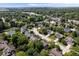 This beautiful aerial shot shows a desirable community near a pond, surrounded by lush landscaping and mature trees at 8827 Lindsey Ct, Fishers, IN 46038
