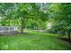 Green backyard and landscaped lawn with a spacious deck for outdoor activities at 8827 Lindsey Ct, Fishers, IN 46038