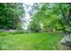 Lush backyard featuring a well-maintained lawn, garden space, and fence perimeter at 8827 Lindsey Ct, Fishers, IN 46038