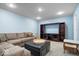 Relaxing finished basement featuring a plush sectional and a large entertainment center at 8827 Lindsey Ct, Fishers, IN 46038