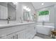 Luxurious bathroom with dual vanities, soaking tub, and modern finishes throughout at 8827 Lindsey Ct, Fishers, IN 46038