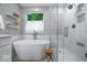 Elegant bathroom featuring a freestanding tub, glass shower, and contemporary fixtures at 8827 Lindsey Ct, Fishers, IN 46038