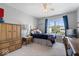 Cozy bedroom featuring a ceiling fan, window views, and neutral paint color at 8827 Lindsey Ct, Fishers, IN 46038