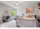 Comfortable bedroom features a cozy bed, study space, and large window with outdoor views at 8827 Lindsey Ct, Fishers, IN 46038