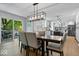 Elegant dining area with sliding glass doors, a modern chandelier, and seamless flow to the kitchen at 8827 Lindsey Ct, Fishers, IN 46038