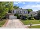 Attractive two-story home featuring a well-maintained lawn, mature trees, and a brick-accented driveway at 8827 Lindsey Ct, Fishers, IN 46038