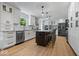 Bright, open kitchen featuring white cabinetry, stainless appliances, and a large center island with seating at 8827 Lindsey Ct, Fishers, IN 46038