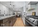 Modern kitchen featuring stainless steel appliances, white cabinets, granite countertops, and an island with seating at 8827 Lindsey Ct, Fishers, IN 46038