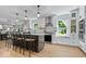 Inviting kitchen with white cabinetry, stainless steel appliances, island with bar seating, and natural light at 8827 Lindsey Ct, Fishers, IN 46038