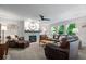 Cozy living room with a fireplace, plush leather seating, ample natural light, and stylish décor at 8827 Lindsey Ct, Fishers, IN 46038