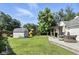 Spacious backyard with lush lawn, storage shed, play set, and wooden deck at 8929 Sunburst Cir, Indianapolis, IN 46227