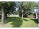 Large, shady backyard with mature trees and a privacy fence at 8929 Sunburst Cir, Indianapolis, IN 46227