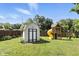 The backyard has a storage shed, wooden playground, and privacy fence at 8929 Sunburst Cir, Indianapolis, IN 46227