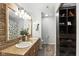 Bright bathroom with double sink vanity, granite countertop, and rustic wood-trimmed mirror at 8929 Sunburst Cir, Indianapolis, IN 46227