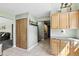 Efficient kitchen area with wood cabinets, tile floor, and easy access to the living area at 8929 Sunburst Cir, Indianapolis, IN 46227