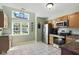 Bright kitchen featuring stainless steel appliances, tile flooring, and a sunny breakfast nook at 8929 Sunburst Cir, Indianapolis, IN 46227